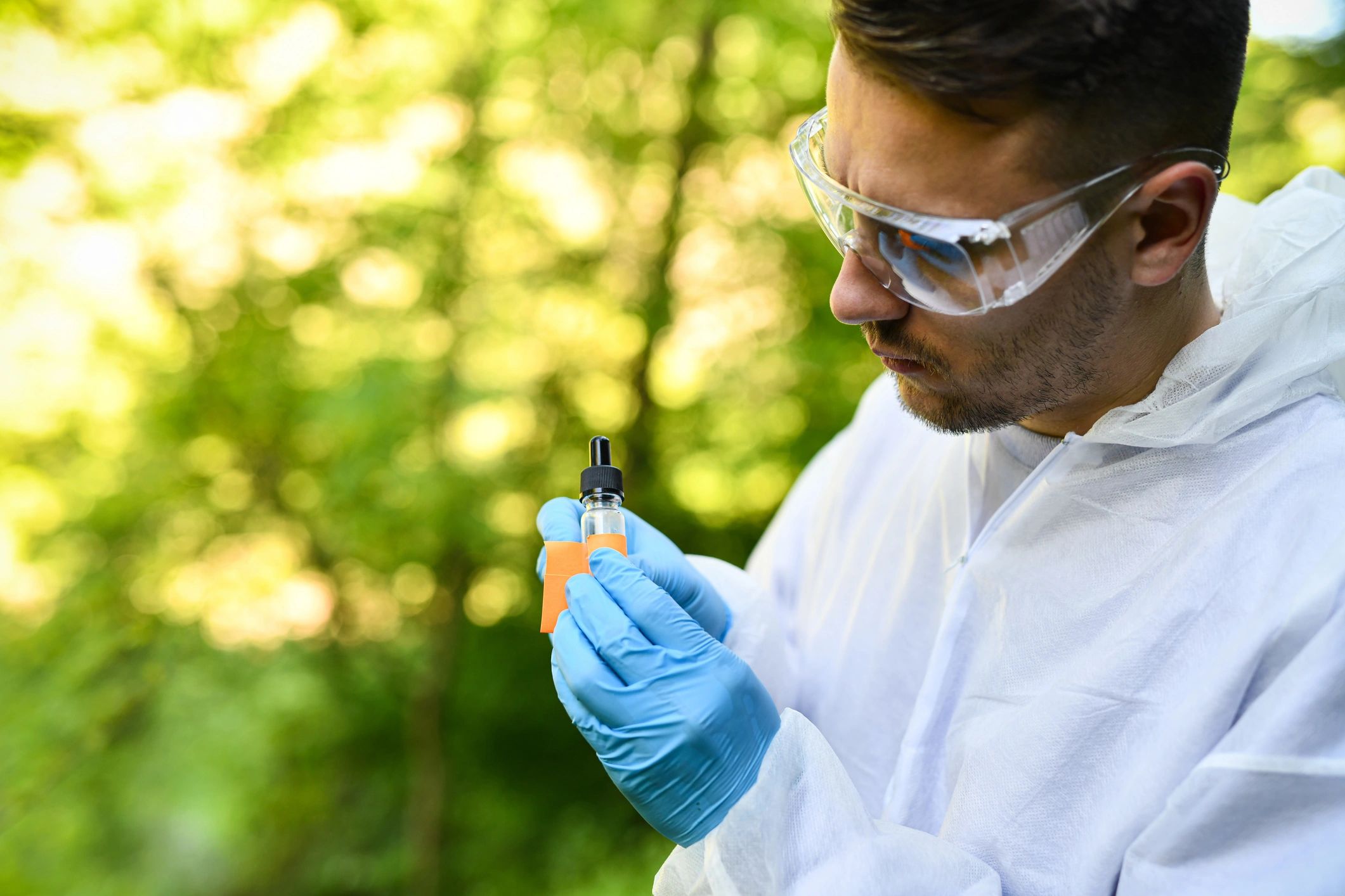 Scientist labeling a sample container