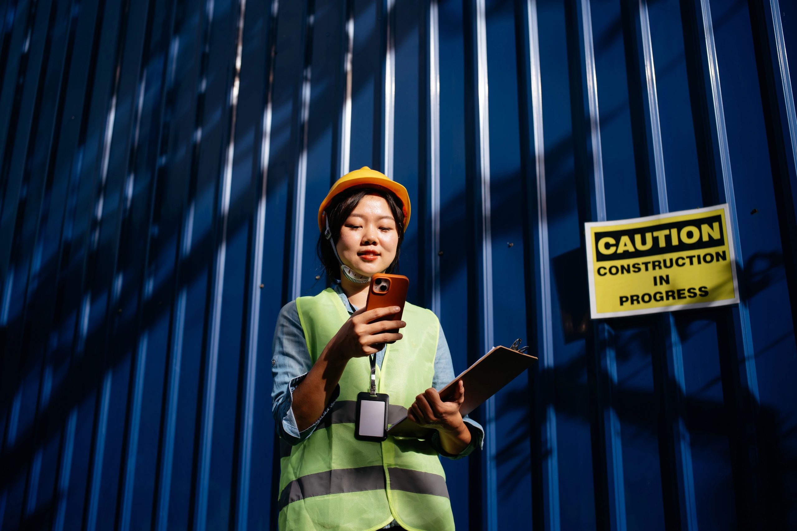 Engineer at a construction site holding a clipboard