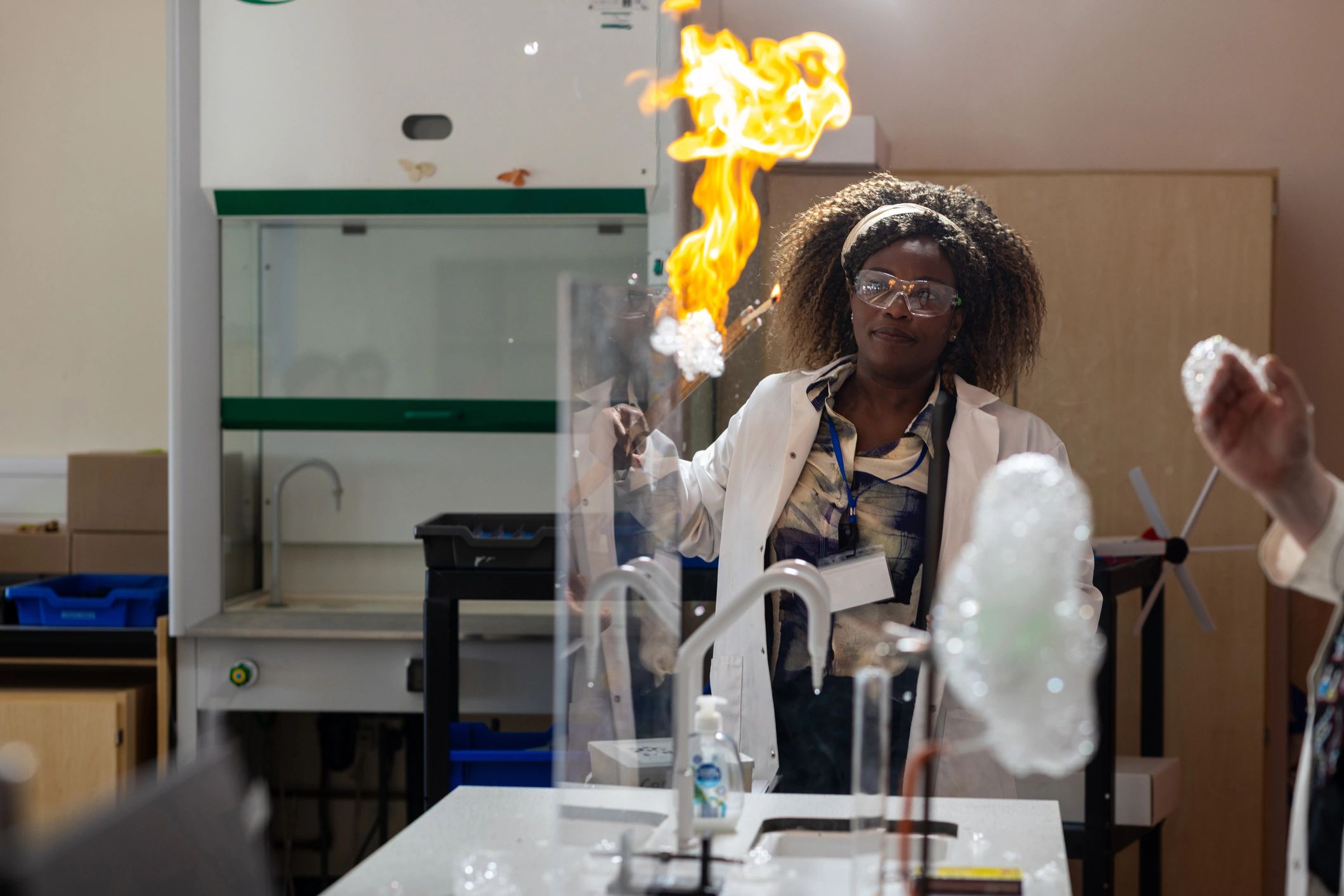 Lab technician in protective eyewear performing a test